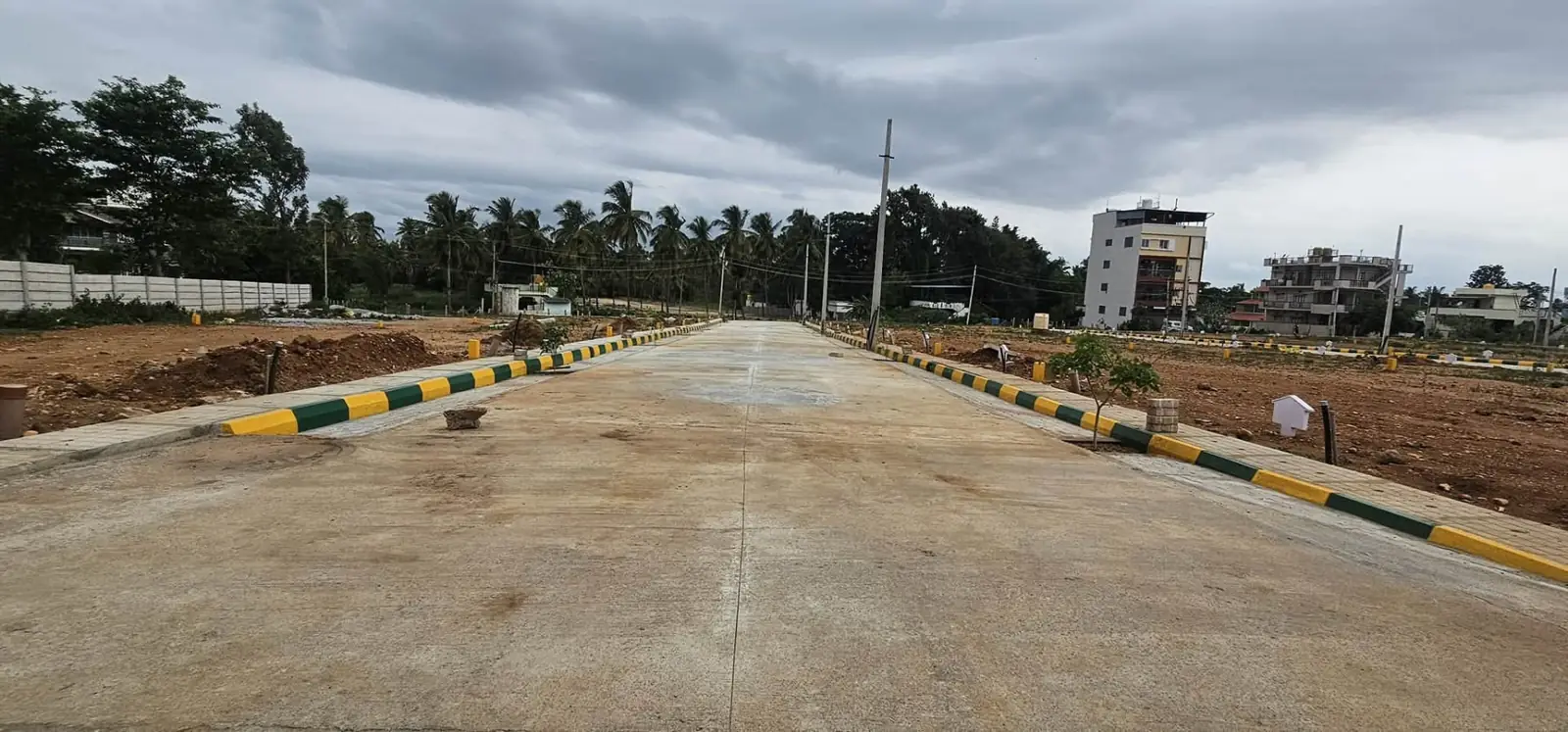 Samartha Layout — central concrete road and avenue